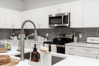 Kitchen with stove top oven and black appliances